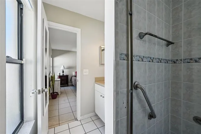 a bathroom with a glass shower door