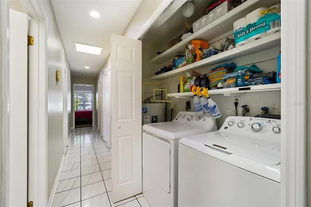 a view of washer and dryer with kitchen in the background