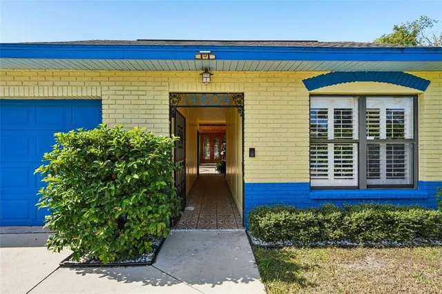 a view of front door of house with potted plants