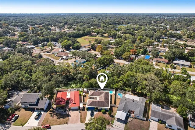 an aerial view of a house with a yard
