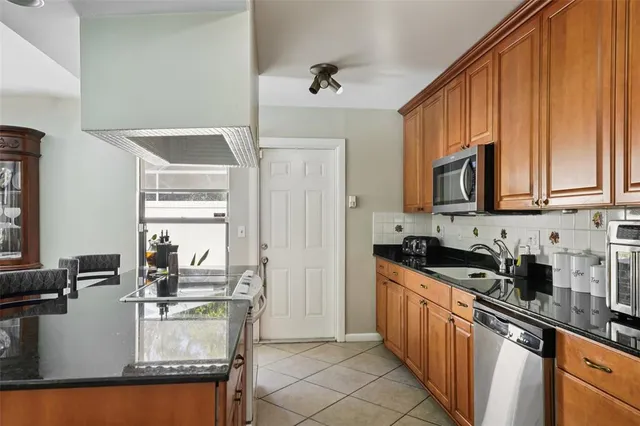 a kitchen with sink a microwave and cabinets