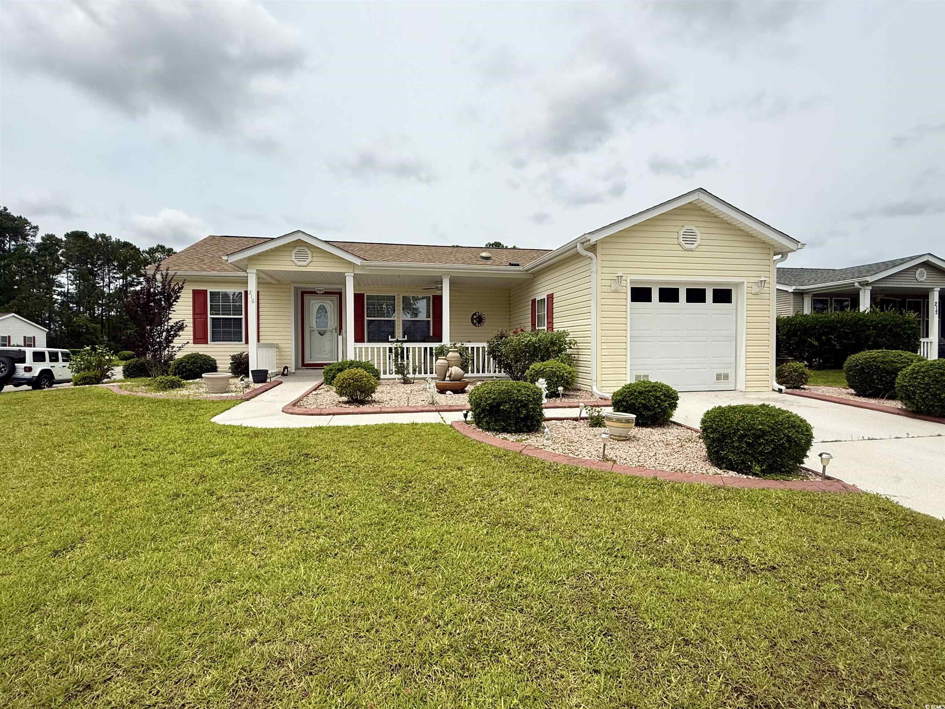 216 Walden Lake Road Conway, SC 29526 - Photo 1 of 40 Ranch-style home featuring covered porch, a garage, driveway, and a front yard
