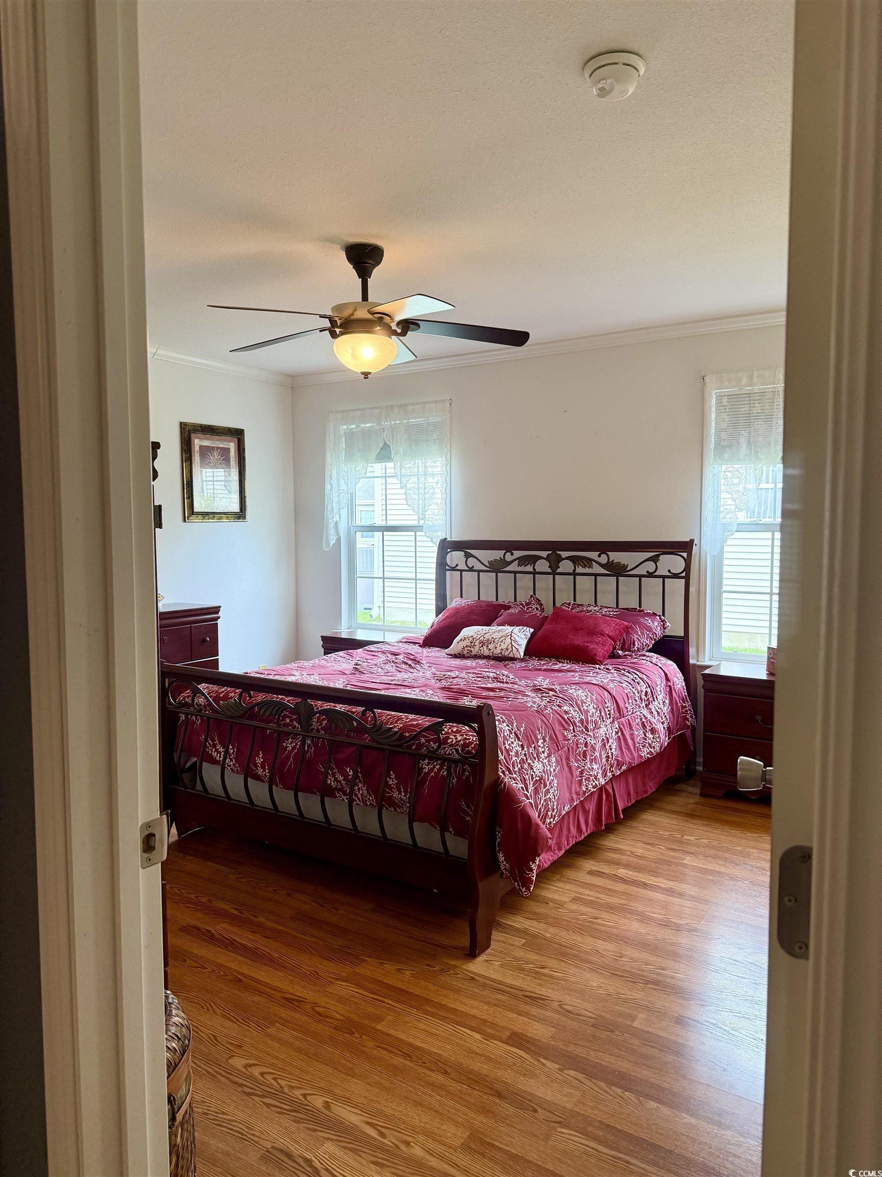 216 Walden Lake Road Conway, SC 29526 - Photo 13 of 40 Bedroom with crown molding, wood finished floors, multiple windows, and ceiling fan
