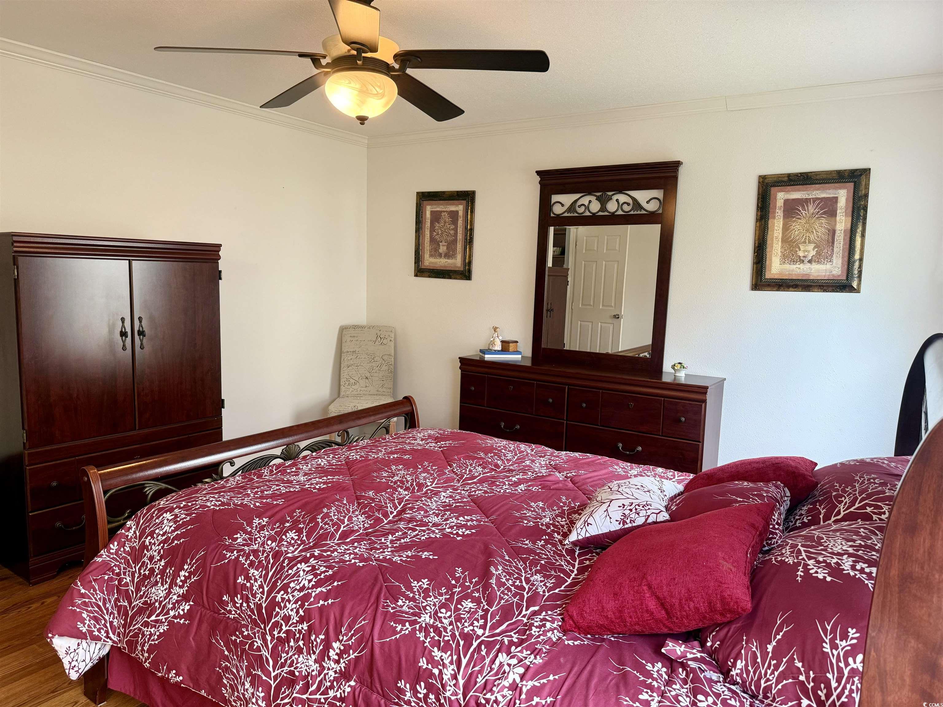 216 Walden Lake Road Conway, SC 29526 - Photo 14 of 40 Bedroom featuring ornamental molding, wood finished floors, and a ceiling fan