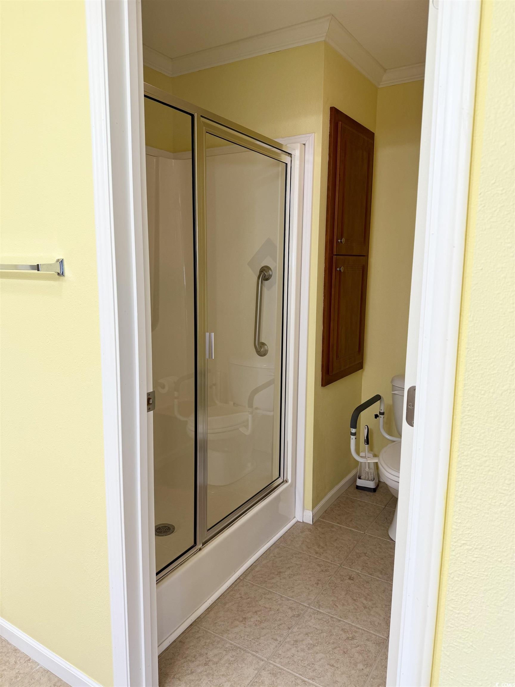 216 Walden Lake Road Conway, SC 29526 - Photo 16 of 40 Bathroom with ornamental molding, a shower stall, toilet, and baseboards