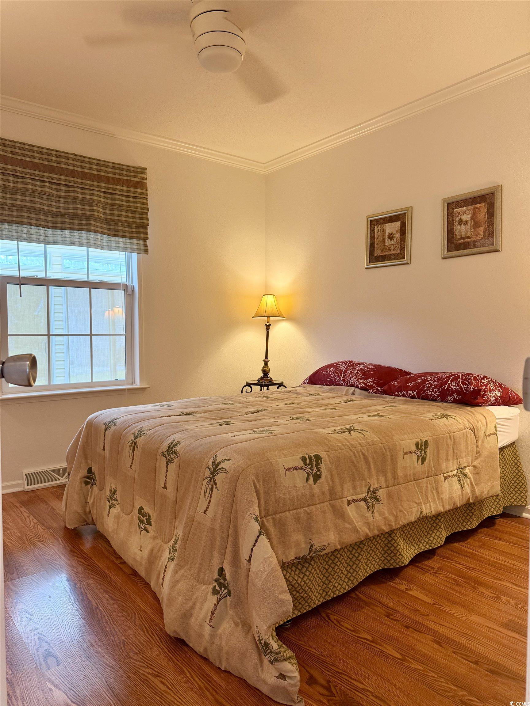 216 Walden Lake Road Conway, SC 29526 - Photo 18 of 40 Bedroom featuring wood finished floors, crown molding, baseboards, and a ceiling fan