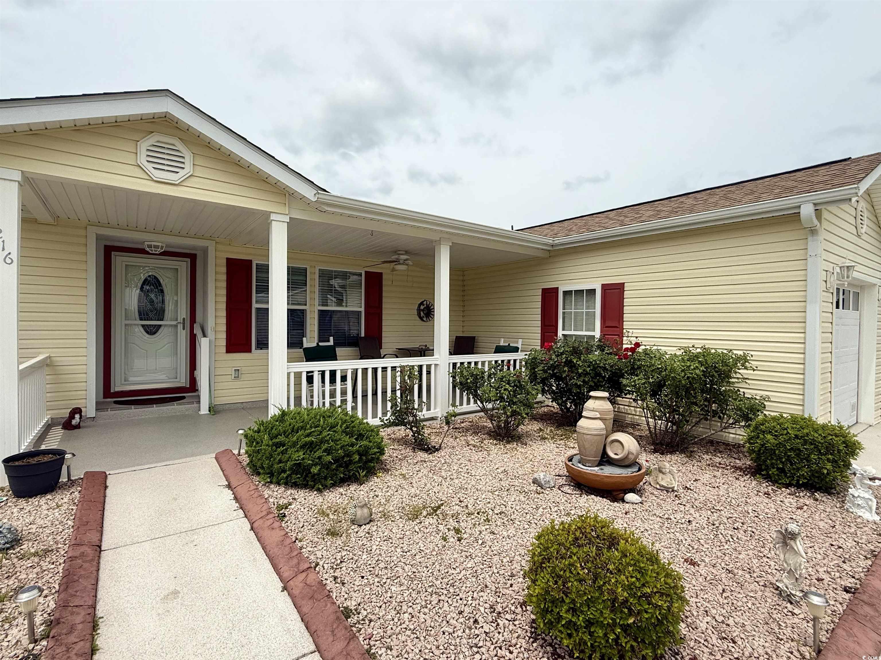 216 Walden Lake Road Conway, SC 29526 - Photo 2 of 40 View of front of house featuring a porch, a garage, and roof with shingles