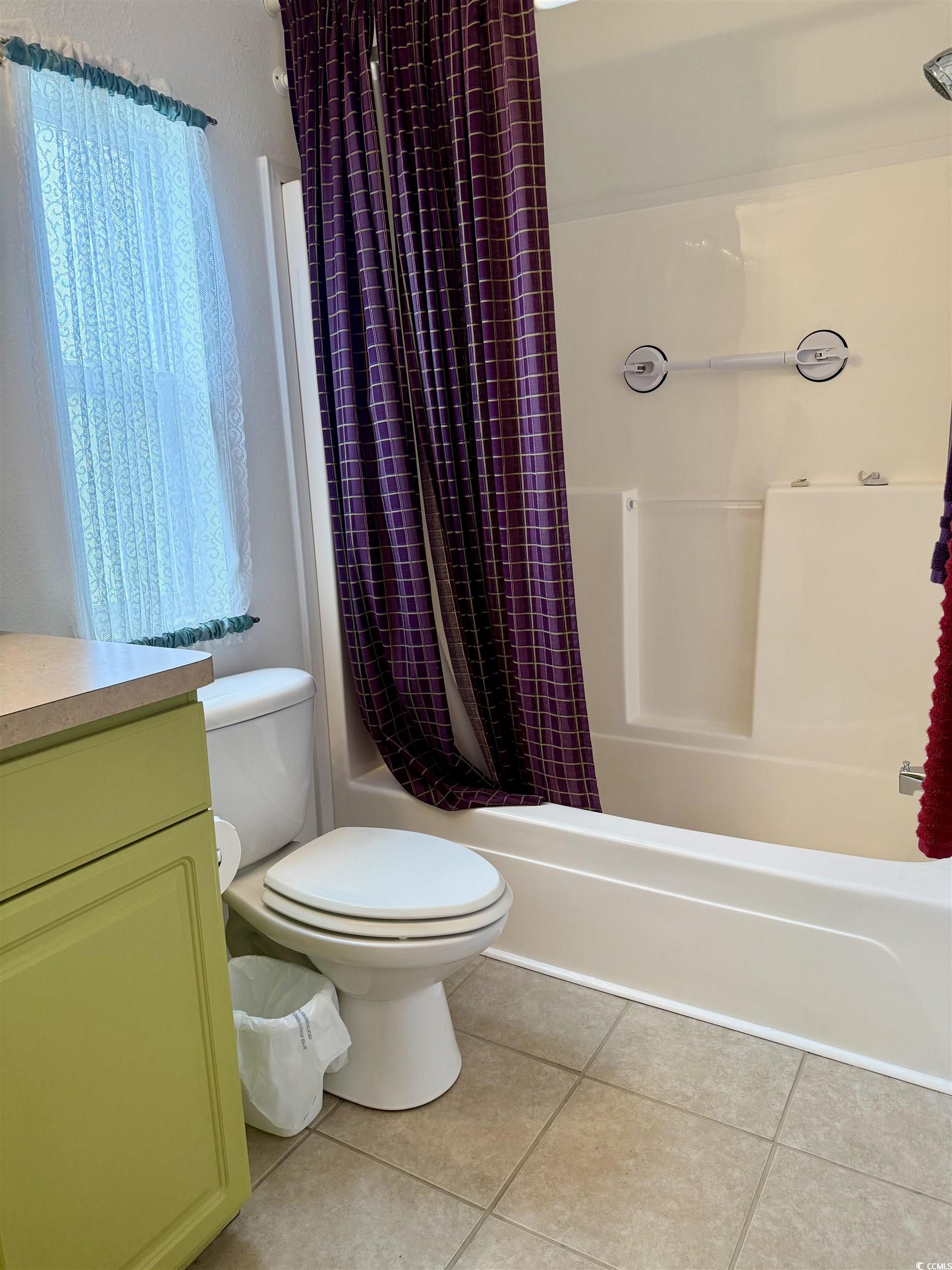 216 Walden Lake Road Conway, SC 29526 - Photo 24 of 40 Bathroom featuring tile patterned flooring, toilet, shower / tub combo with curtain, and vanity