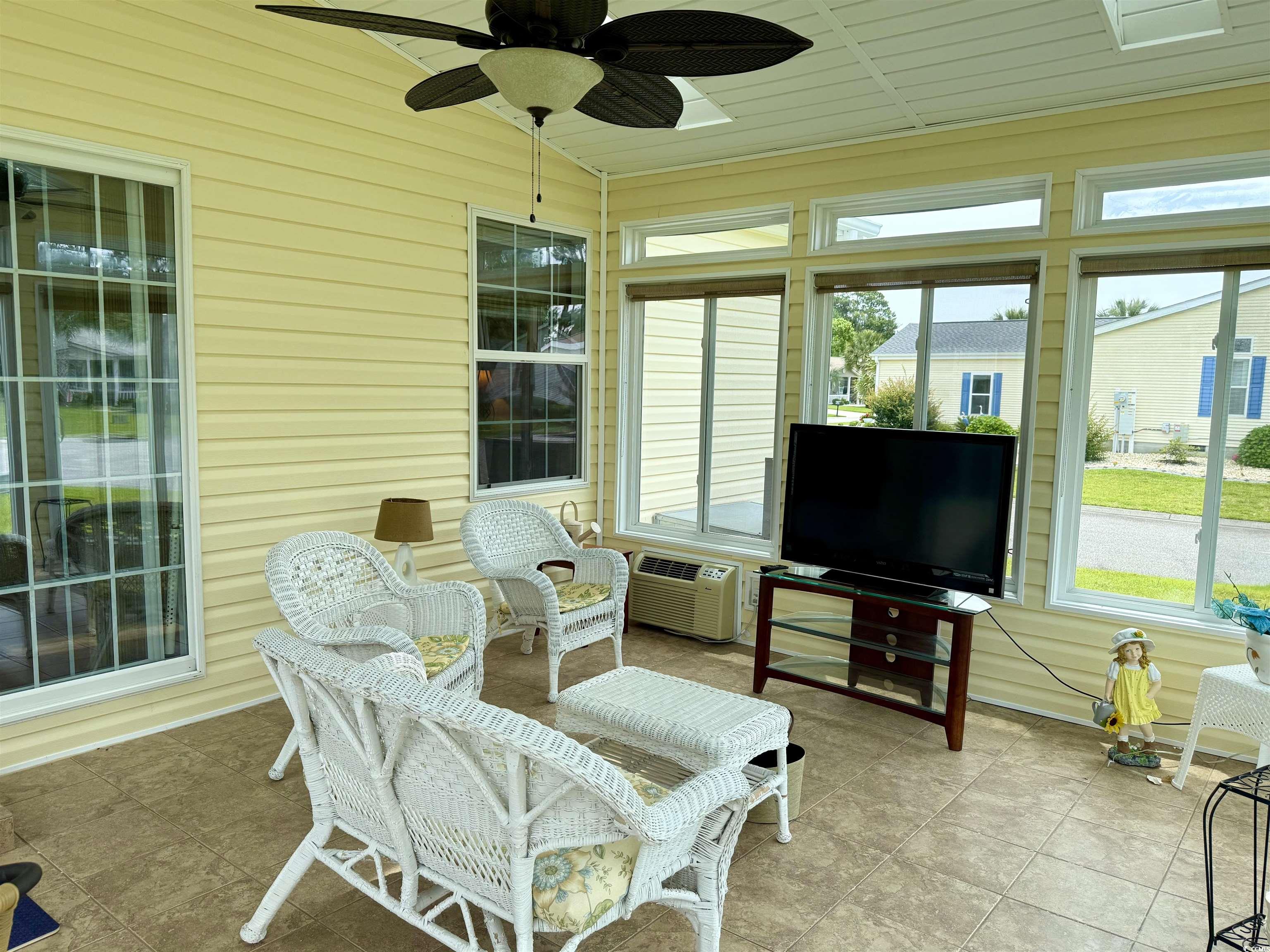 216 Walden Lake Road Conway, SC 29526 - Photo 27 of 40 Sunroom / solarium featuring a wall mounted AC, ceiling fan, and vaulted ceiling