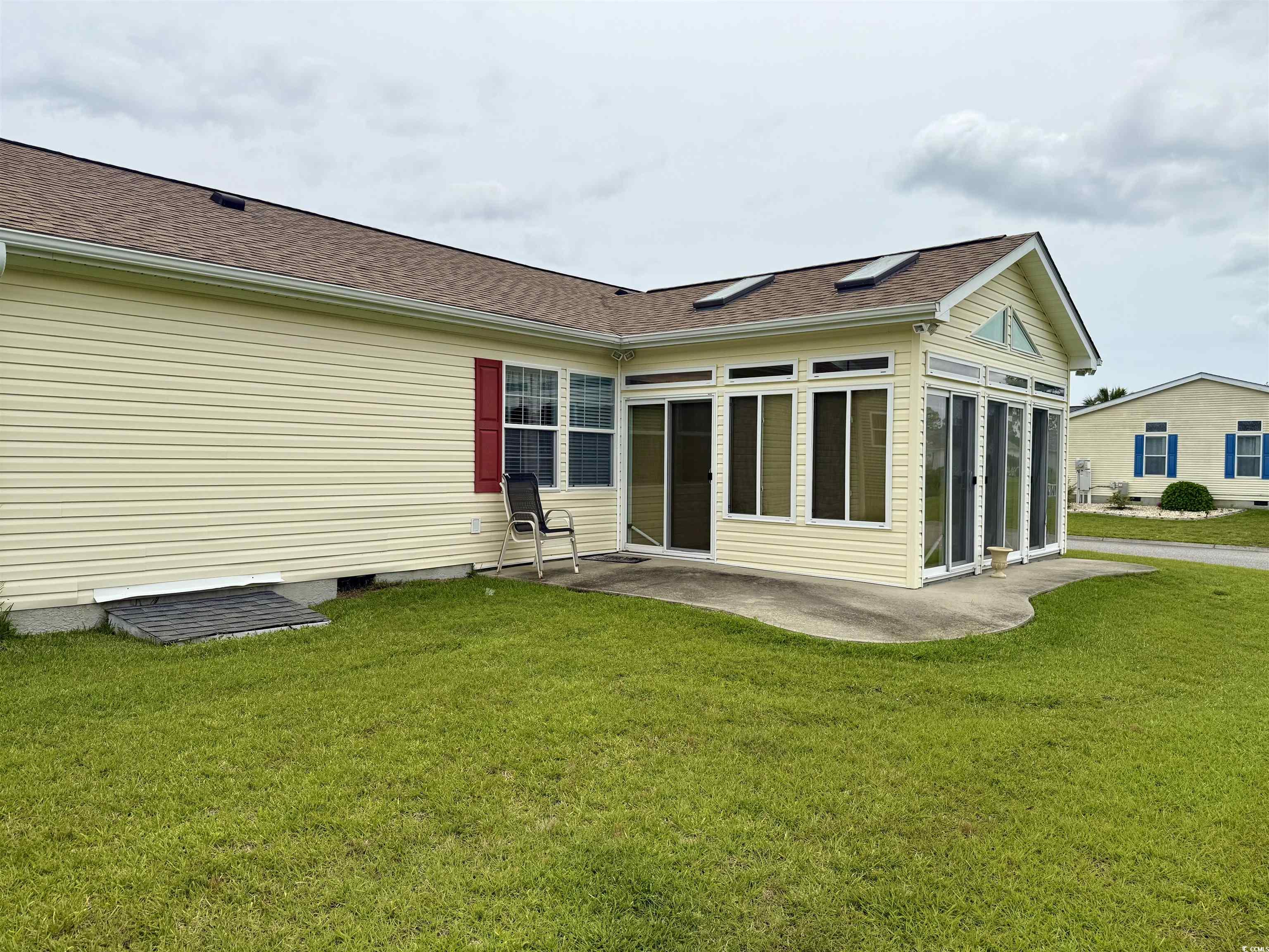 216 Walden Lake Road Conway, SC 29526 - Photo 4 of 40 Rear view of house featuring a lawn, crawl space, a shingled roof, and a sunroom