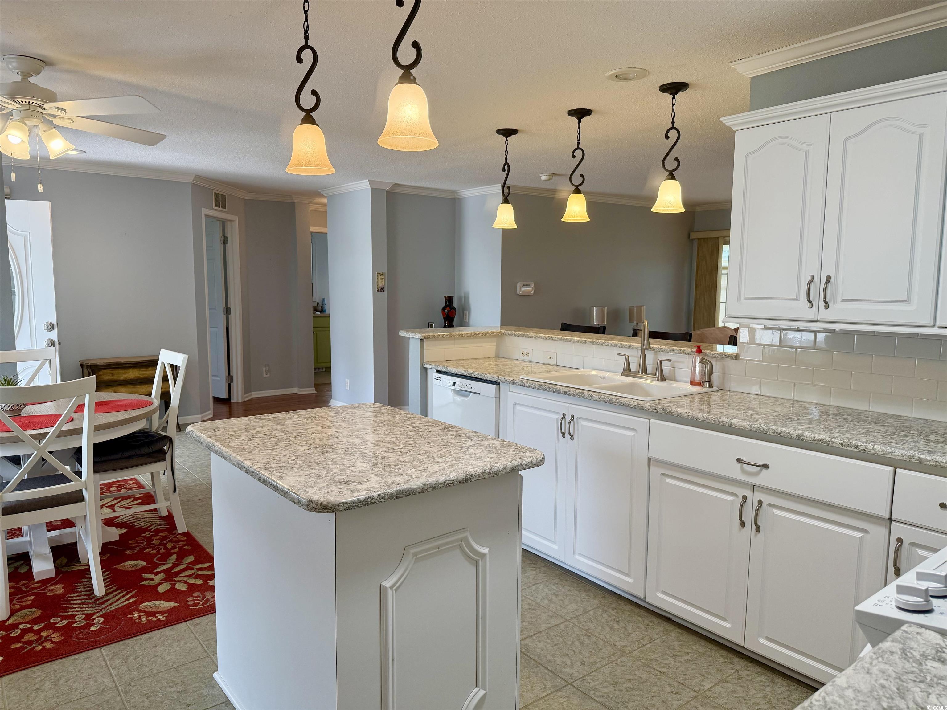 216 Walden Lake Road Conway, SC 29526 - Photo 7 of 40 Kitchen with a sink, white dishwasher, crown molding, a ceiling fan, and decorative backsplash