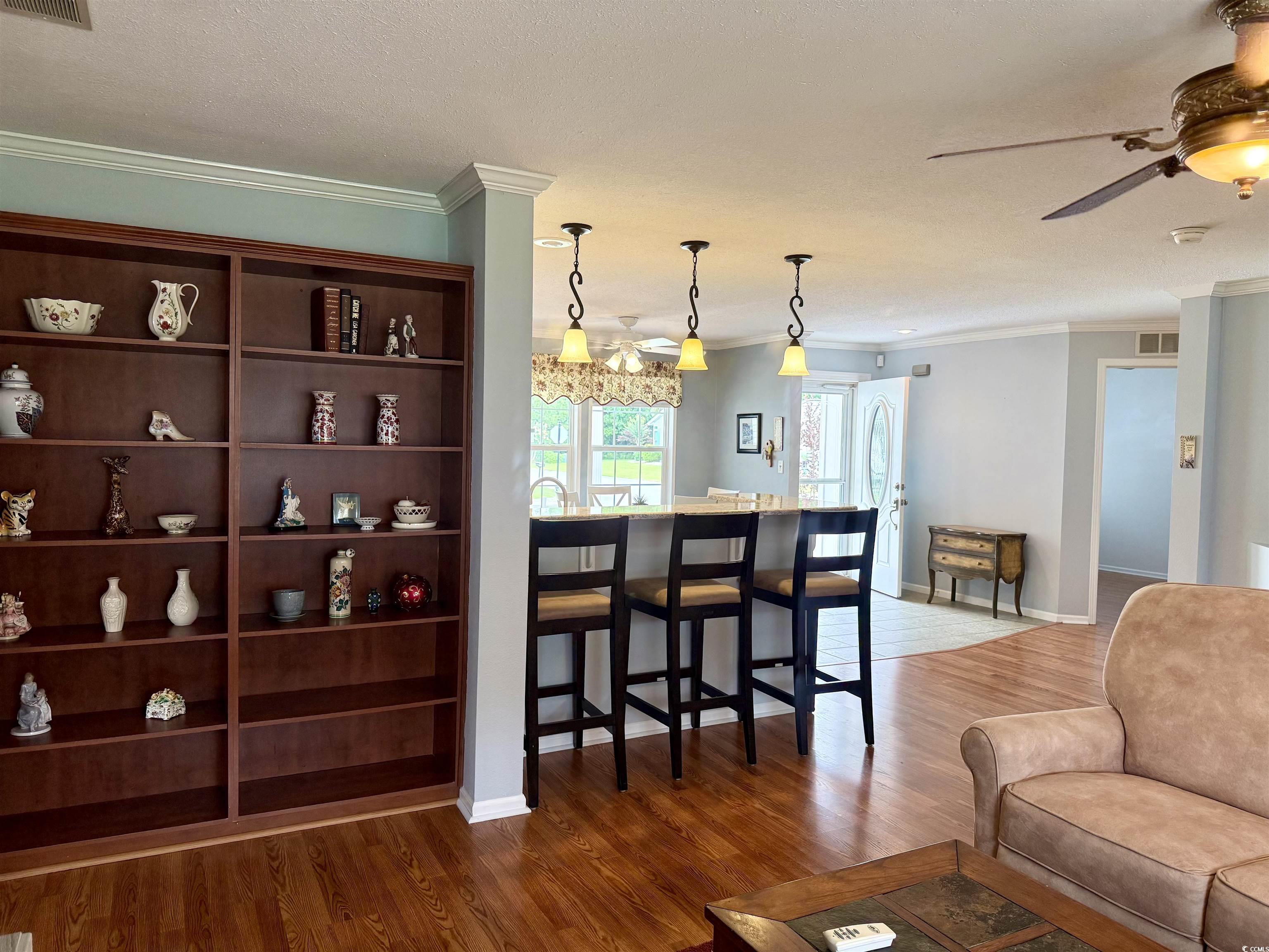 216 Walden Lake Road Conway, SC 29526 - Photo 10 of 40 Living area with ornamental molding, wood finished floors, a ceiling fan, and baseboards
