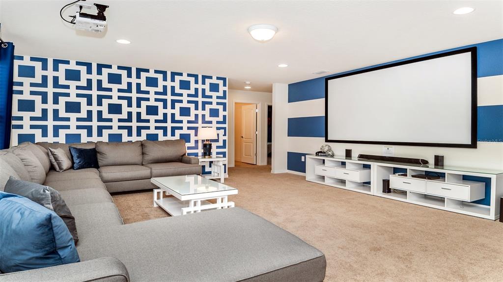 8894 Qin Loop Davenport, FL 33896 - Photo 11 of 47 a living room with furniture and a flat screen tv