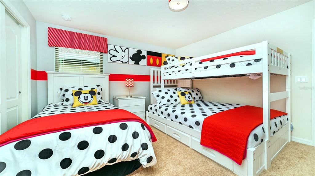 8894 Qin Loop Davenport, FL 33896 - Photo 12 of 47 a bedroom with a bed and a dresser in it