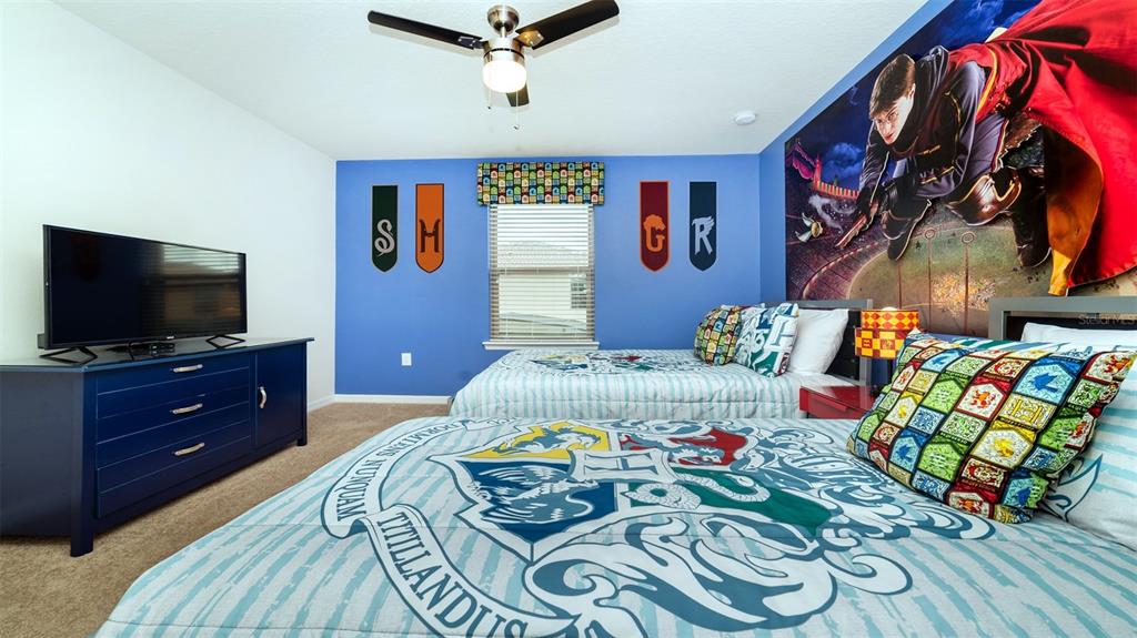 8894 Qin Loop Davenport, FL 33896 - Photo 13 of 47 a bedroom with a bed and wooden floor