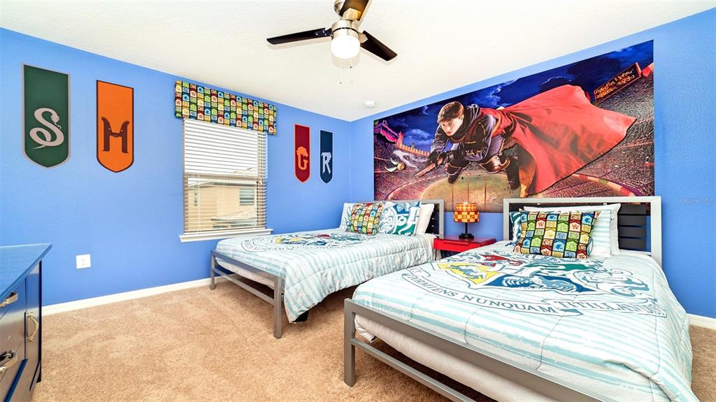 8894 Qin Loop Davenport, FL 33896 - Photo 14 of 47 a bedroom with a bed dresser and a large window