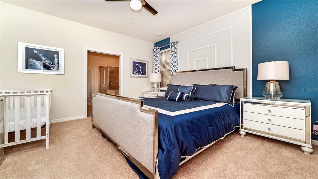 8894 Qin Loop Davenport, FL 33896 - Photo 17 of 47 a bedroom with a bed and a night stand