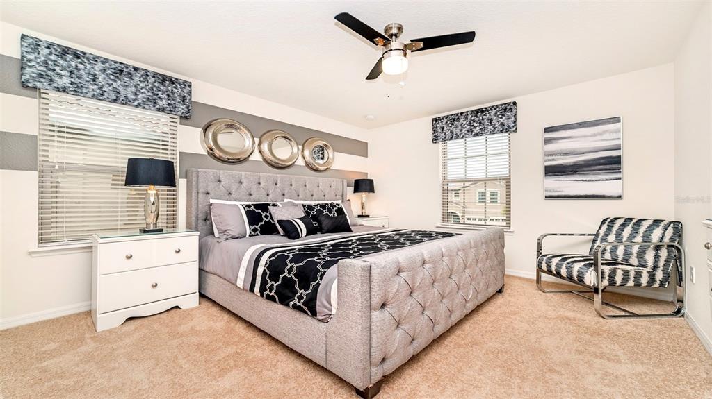8894 Qin Loop Davenport, FL 33896 - Photo 19 of 47 a bedroom with bed and a window