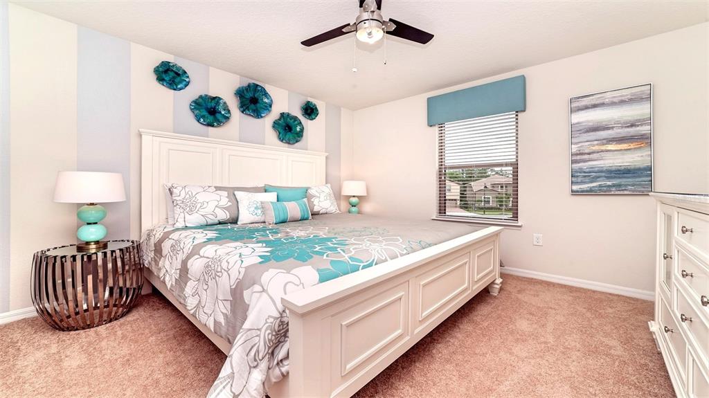 8894 Qin Loop Davenport, FL 33896 - Photo 20 of 47 a bedroom with a bed and a window