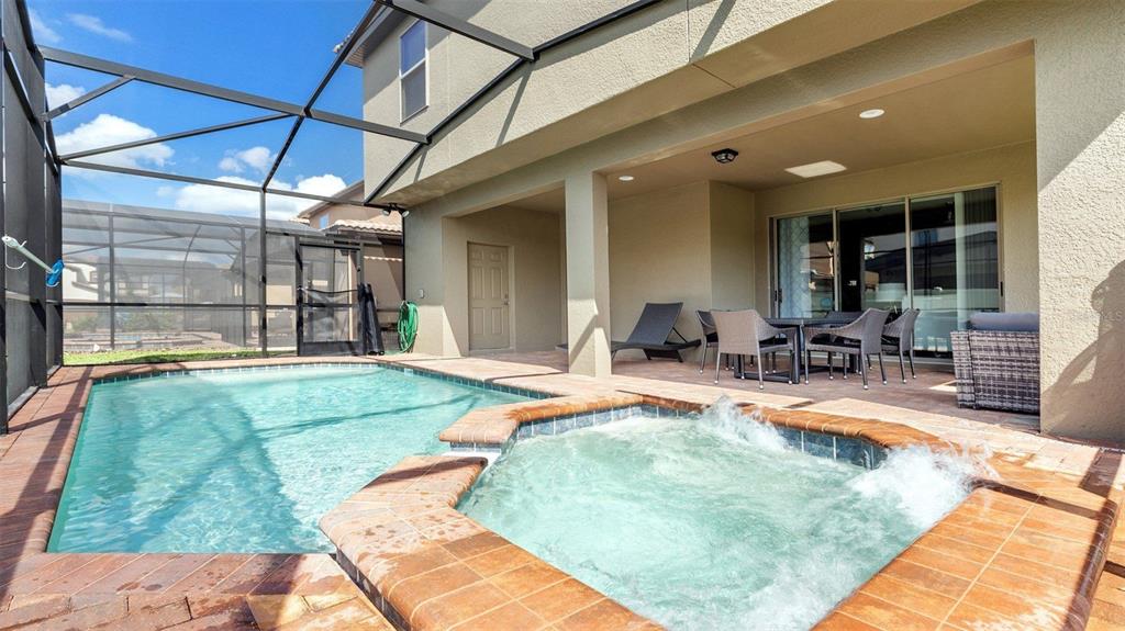8894 Qin Loop Davenport, FL 33896 - Photo 24 of 47 a swimming pool with outdoor seating and yard