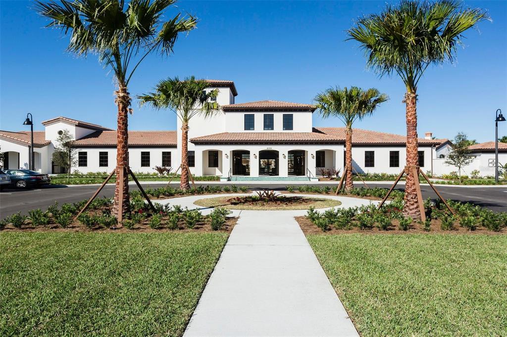8894 Qin Loop Davenport, FL 33896 - Photo 30 of 47 front view of a house with a yard and potted plants