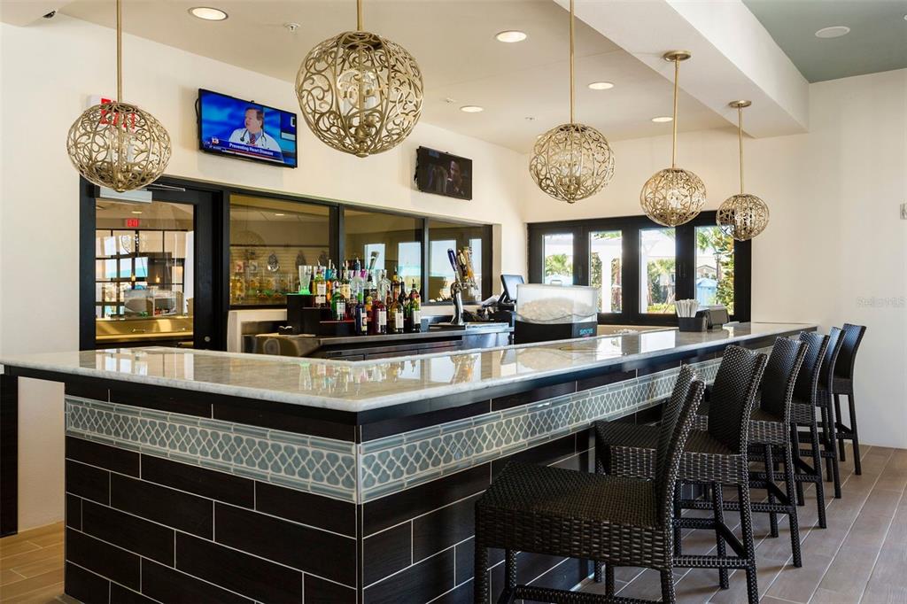 8894 Qin Loop Davenport, FL 33896 - Photo 32 of 47 a view of a dining room and chandelier
