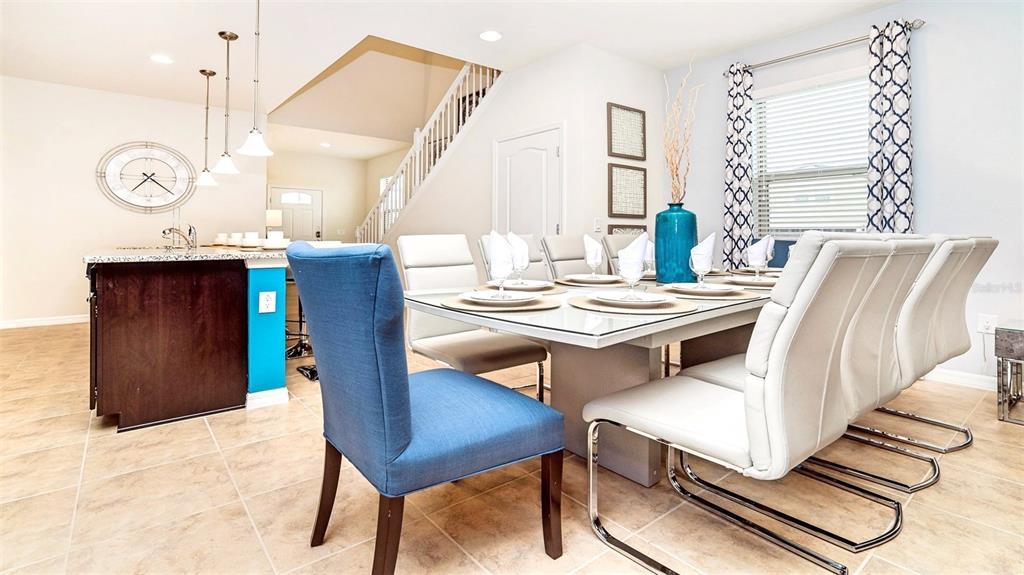 8894 Qin Loop Davenport, FL 33896 - Photo 5 of 47 a view of a dining room with furniture