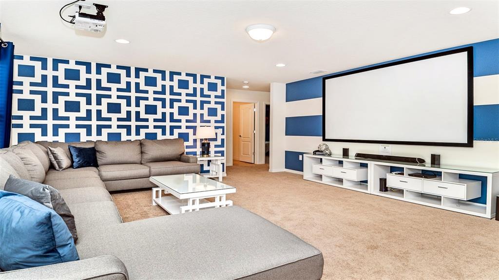 8894 Qin Loop Davenport, FL 33896 - Photo 9 of 47 a living room with furniture and a flat screen tv