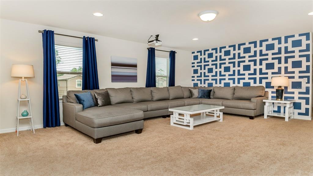8894 Qin Loop Davenport, FL 33896 - Photo 10 of 47 a living room with furniture and a large window
