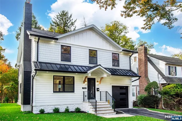 a view of a house with brick walls and a yard with plants