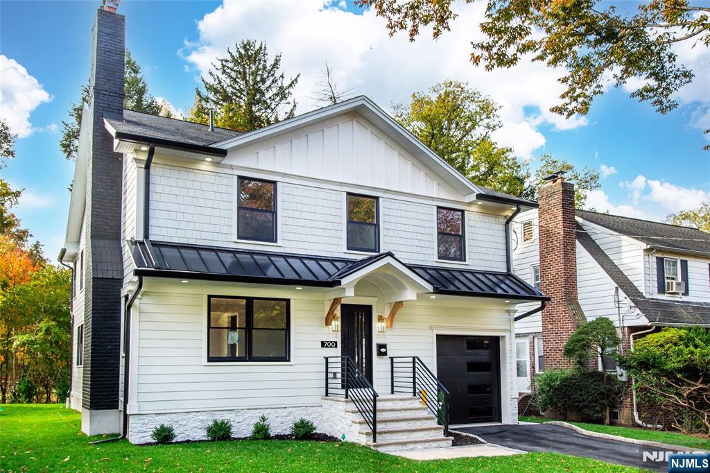 a view of a house with brick walls and a yard with plants