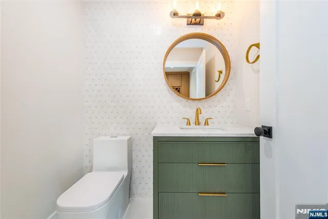 a kitchen with kitchen island a counter top space a sink stainless steel appliances and cabinets