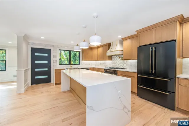 a kitchen with a refrigerator stove and sink