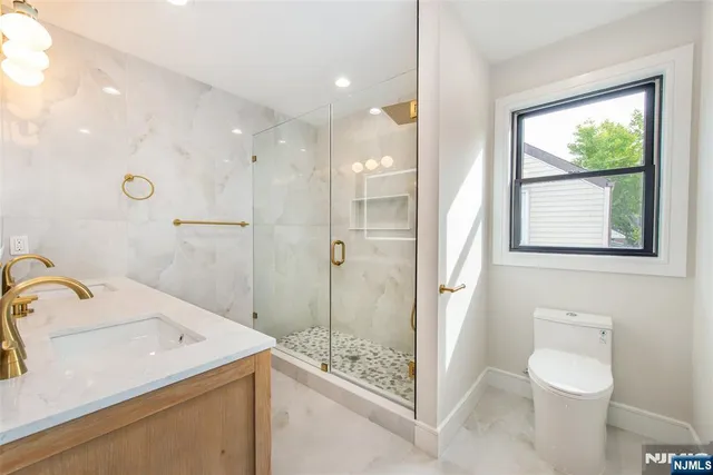 a view of walk in closet with wooden floor