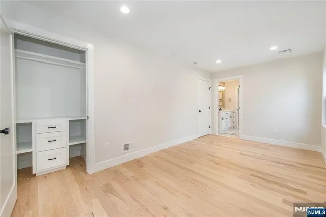 a view of an empty room and wooden floor