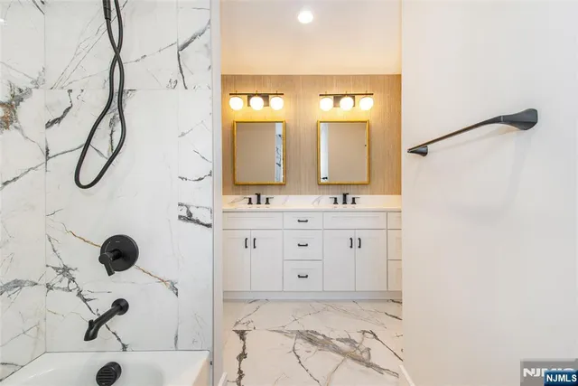 a bathroom with a double vanity sink mirror and