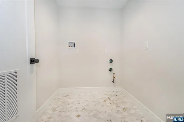 an empty room with windows and a bathroom