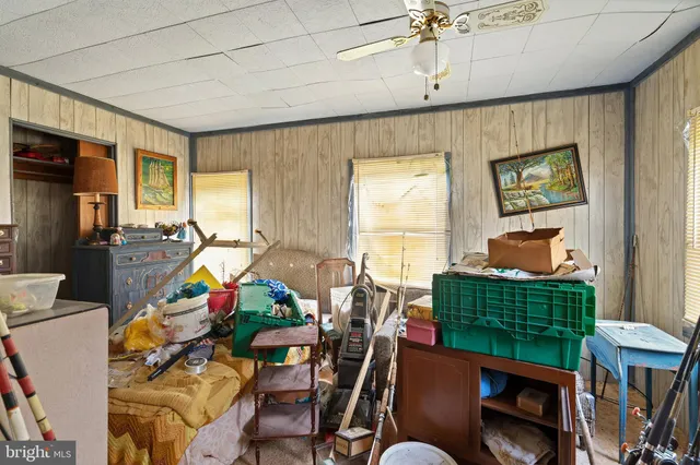 a living room with furniture a window and gym equipment