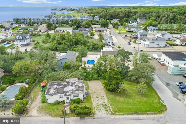 an aerial view of a house with a yard basket ball court and outdoor seating