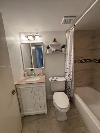 a bathroom with a toilet a sink and bathtub