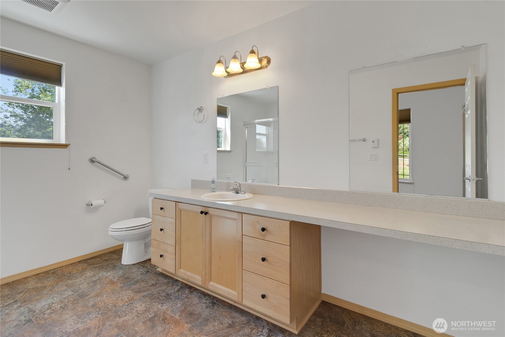 1450 Southeast Spruce Road Port Orchard, WA 98367 - Photo 27 of 39 a spacious bathroom with a granite countertop toilet a sink and a mirror