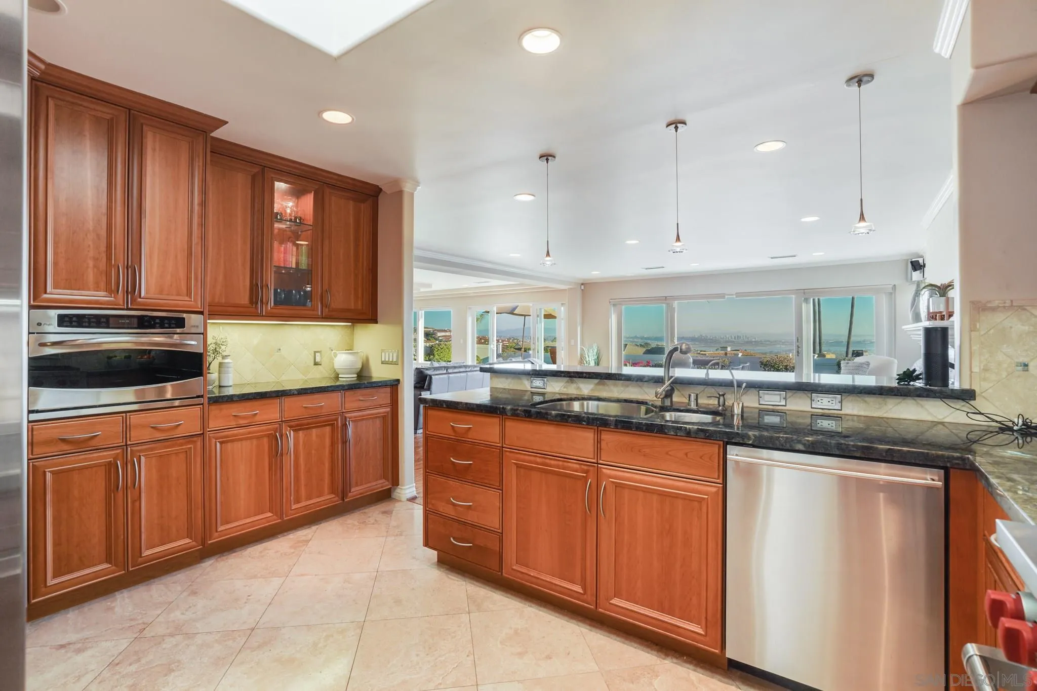 5730 Rutgers Road La Jolla, CA 92037 - Photo 15 of 54 a kitchen with granite countertop sink stove and cabinets