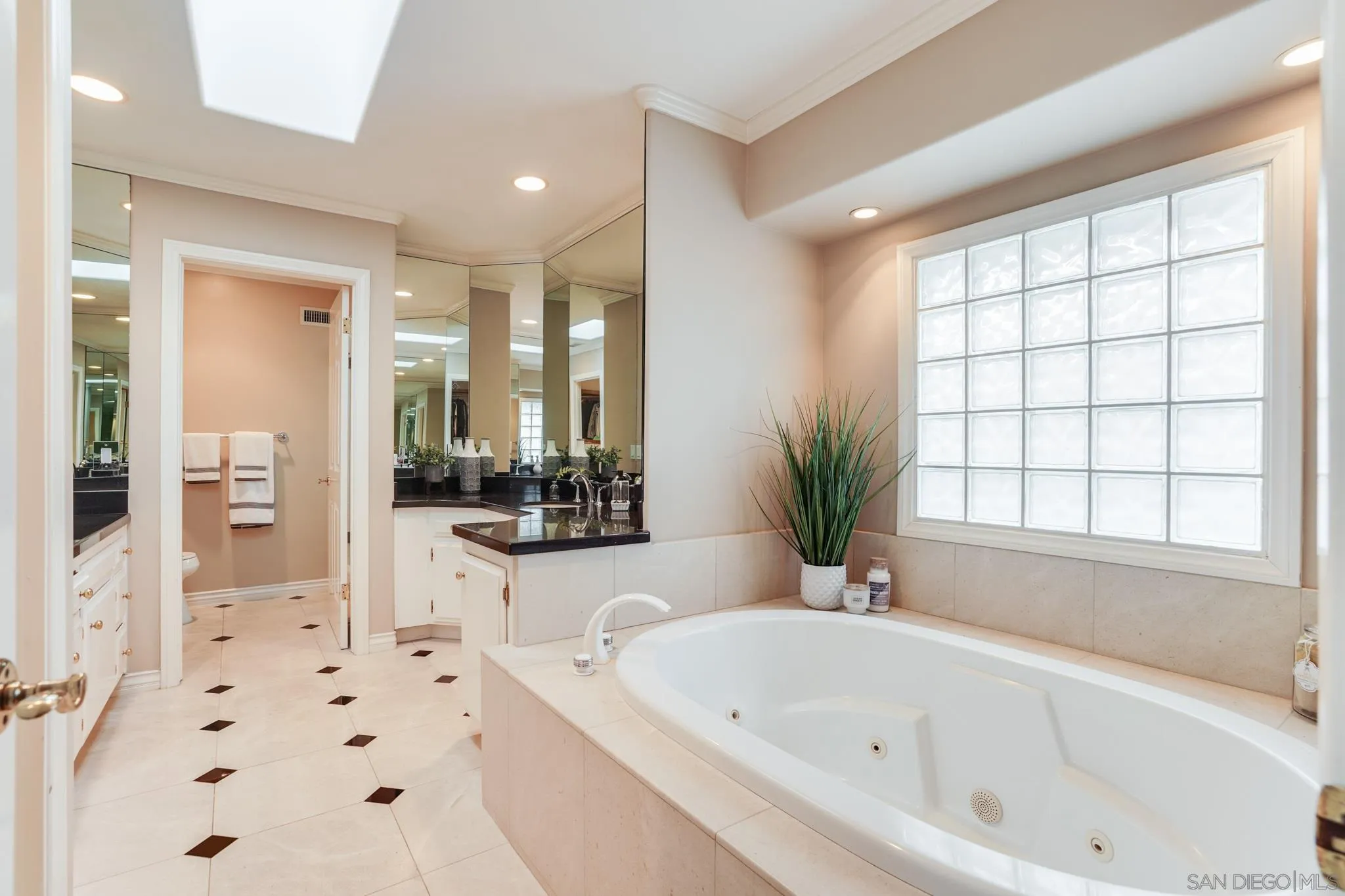 5730 Rutgers Road La Jolla, CA 92037 - Photo 18 of 54 a bathroom with a bathtub a sink a window and a shower