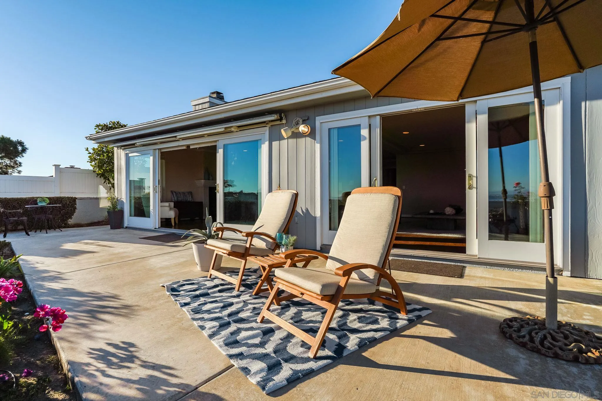 5730 Rutgers Road La Jolla, CA 92037 - Photo 34 of 54 a view of a patio with table and chairs under an umbrella