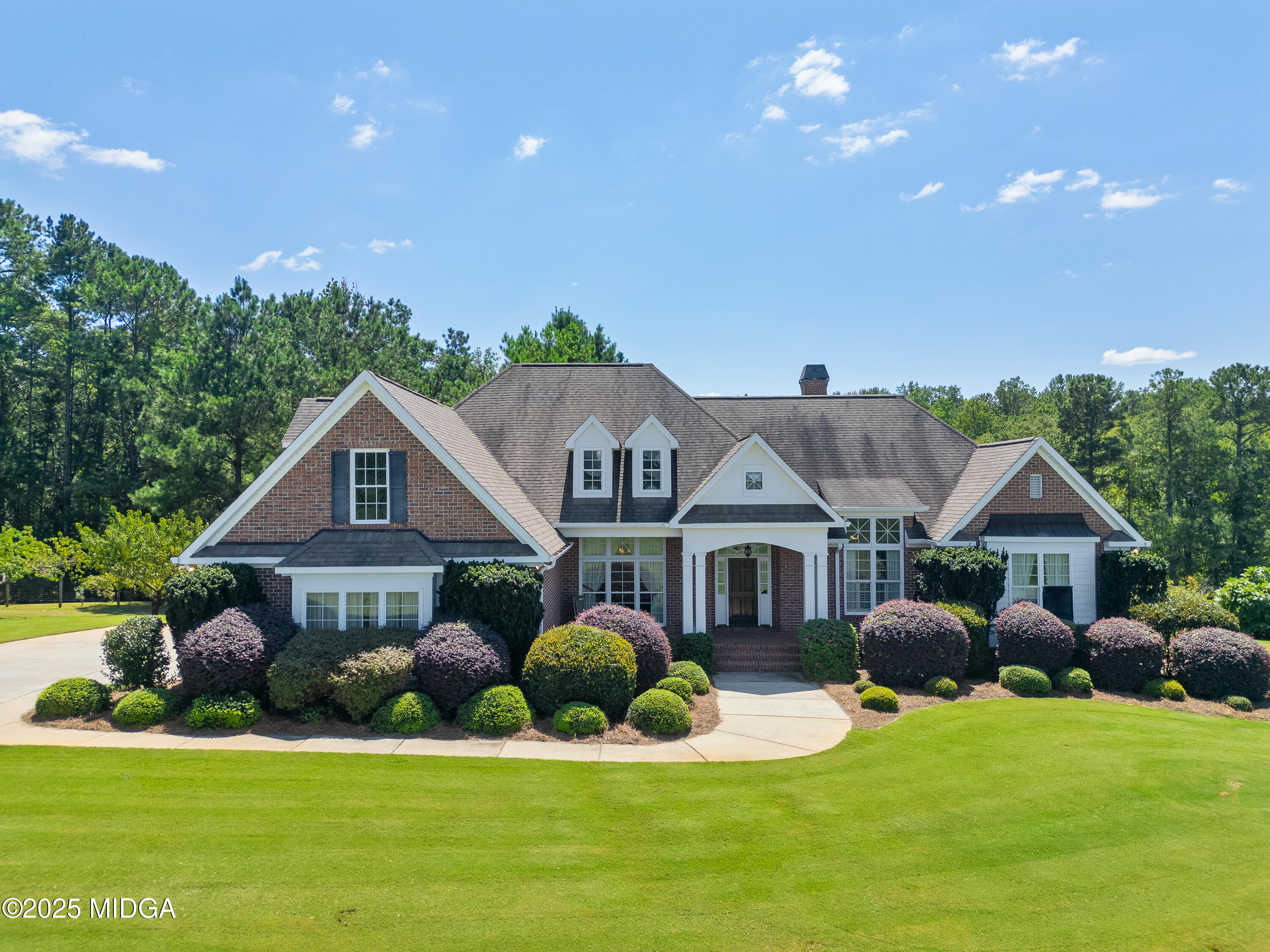 a front view of house with yard and green space