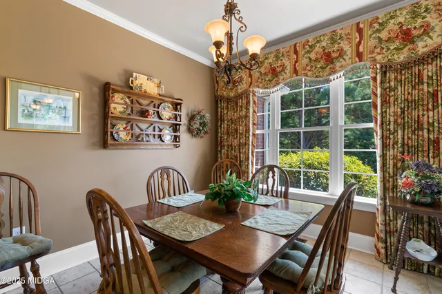 a living room with furniture and painting on the wall