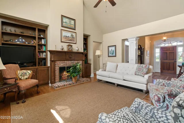 a bathroom with a granite countertop sink a mirror and shower