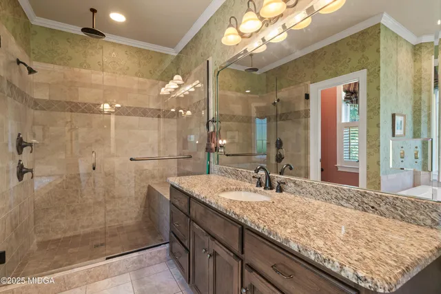 a bathroom with a granite countertop toilet sink and mirror