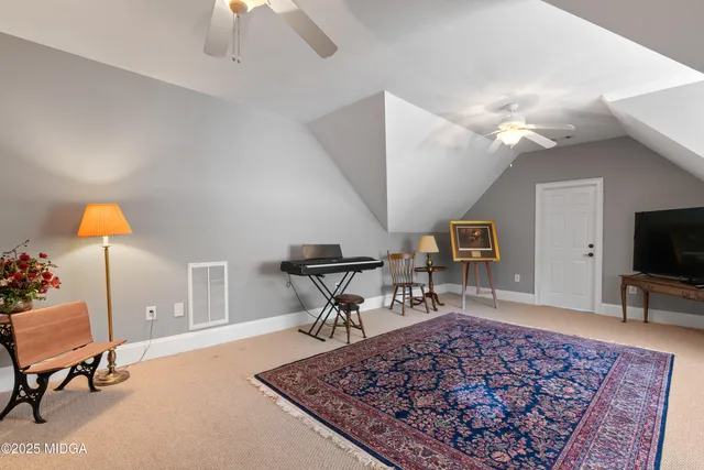 an aerial view of a house with a yard and lake view