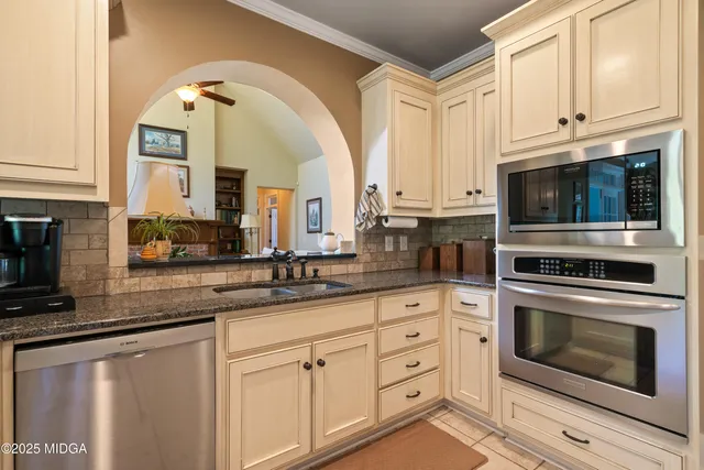 a view of a dining room with furniture wooden floor and chandelier